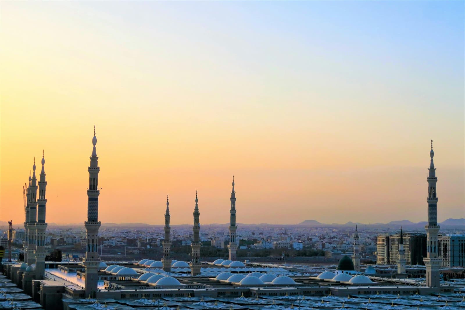 Al-Masjid an-Nabawi in Madinah with its minarets and the Green Dome at sunset